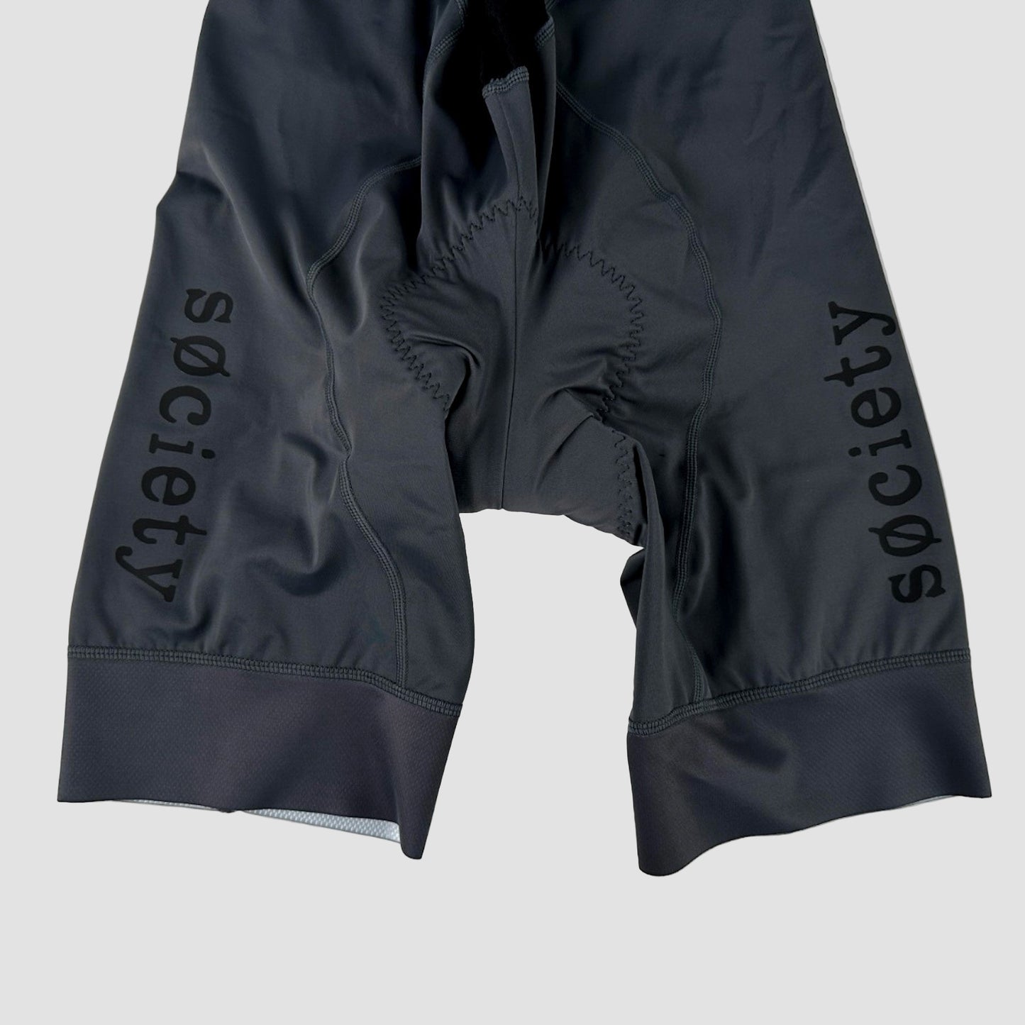 Black cycling shorts with 'Society' branding on a white background