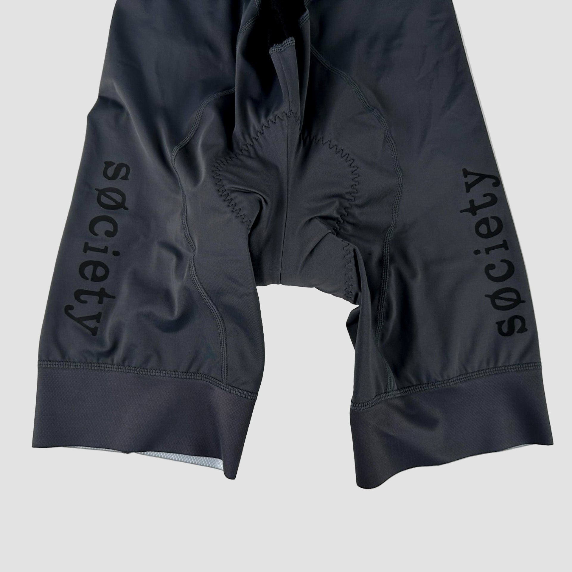Black cycling shorts with 'Society' branding on a white background